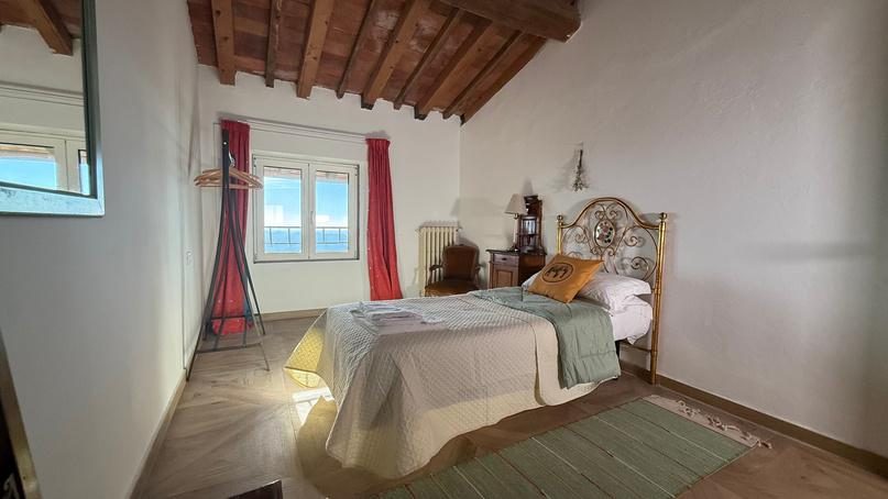 Bedroom with a window over the hills