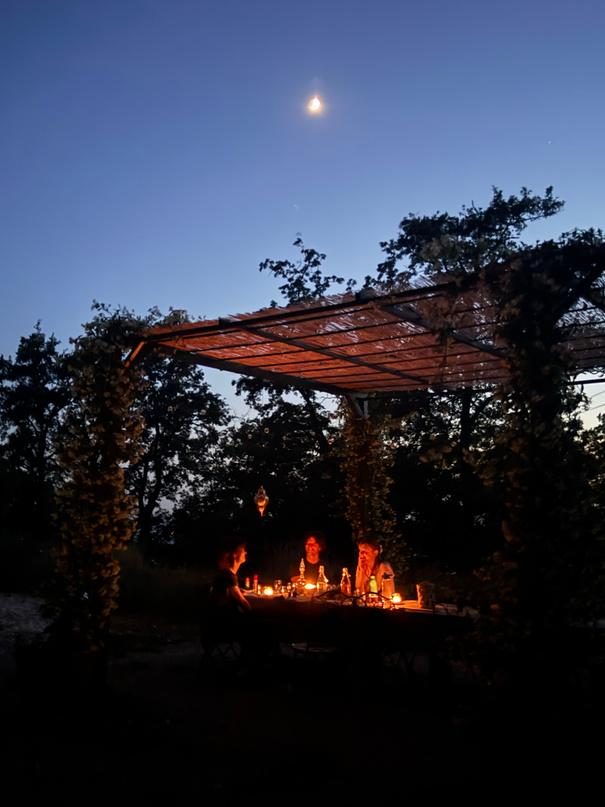 The pergola at blue hour with a fire beneath